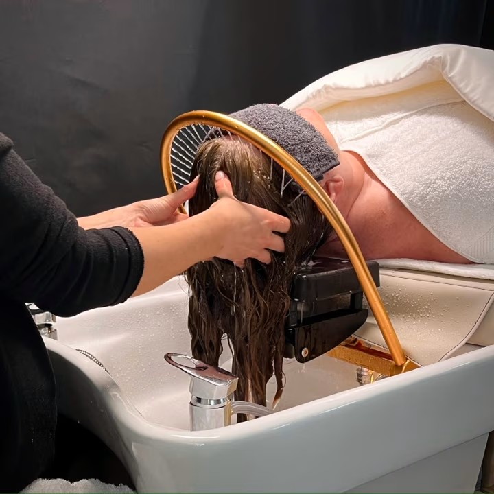 Stylist performing a Japanese head spa scalp treatment at Sacred Roots in Asheville, NC